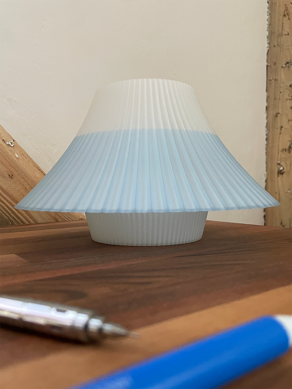 3D printed blue and white Fuji desk lamp on a wooden desk