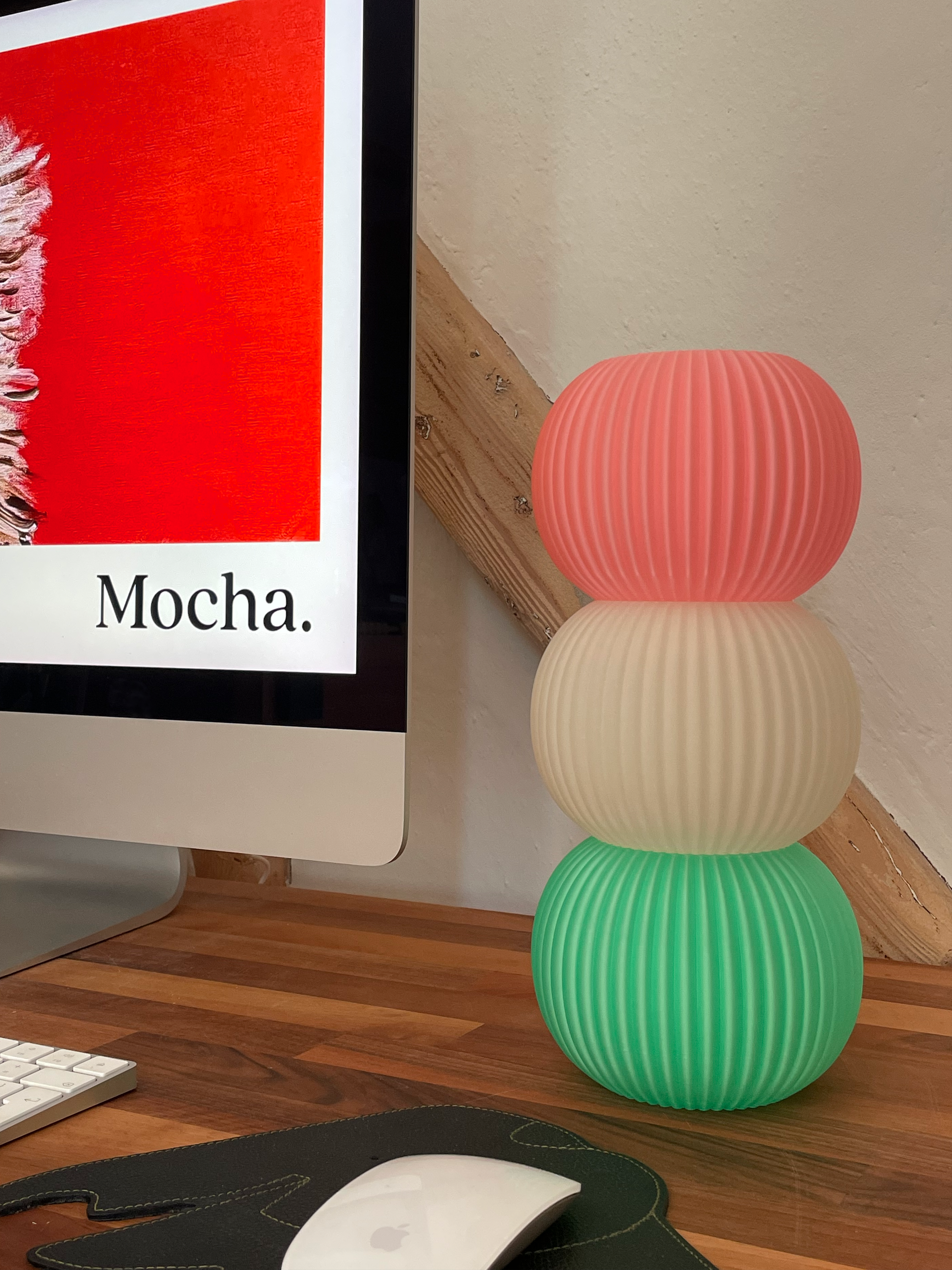 3d printed pink, white and green Dango lamp on wooden desk