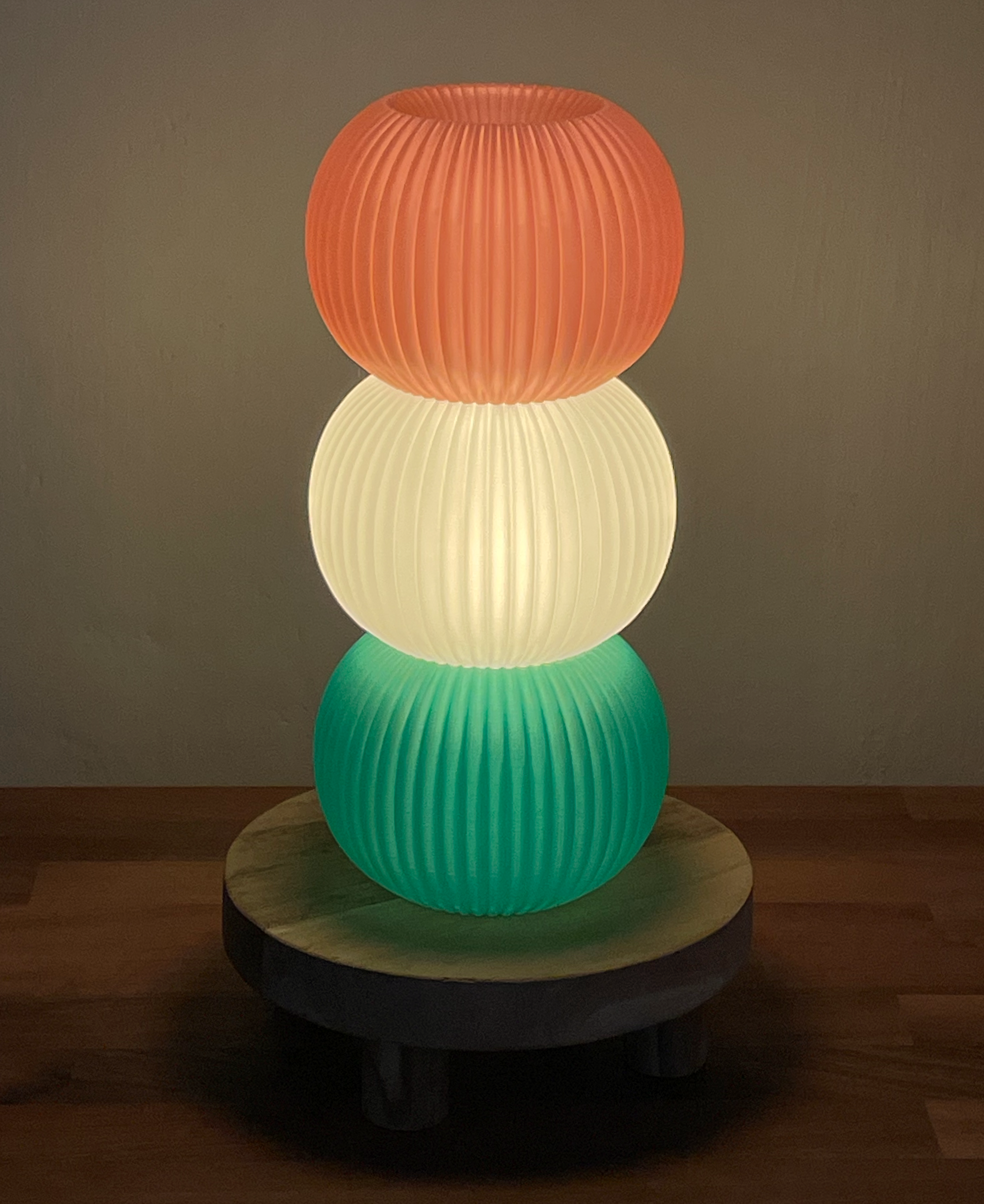 Pink, white and green hanami dango lamp on a wooden stand
