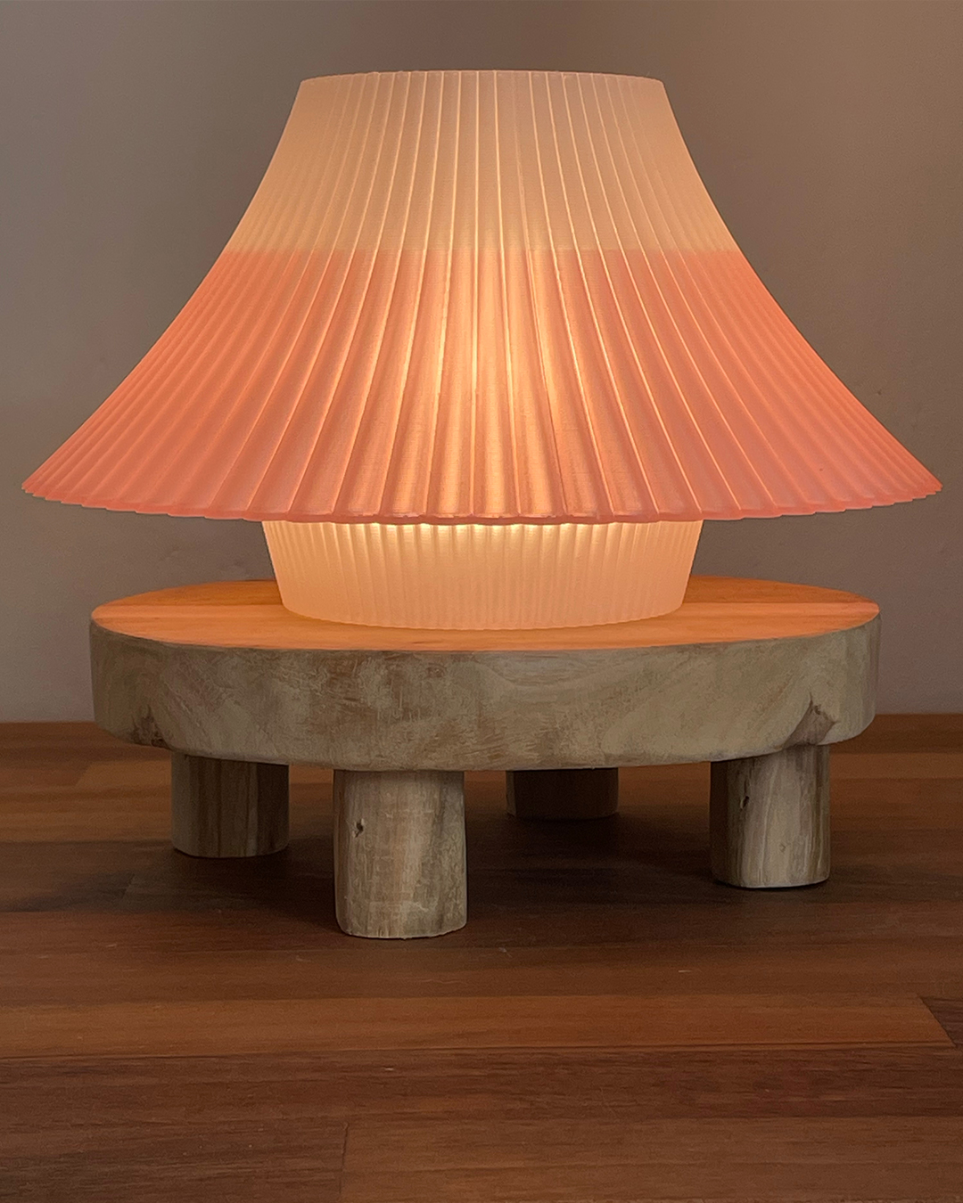 3D printed pink and white Fuji desk lamp on a wooden stand