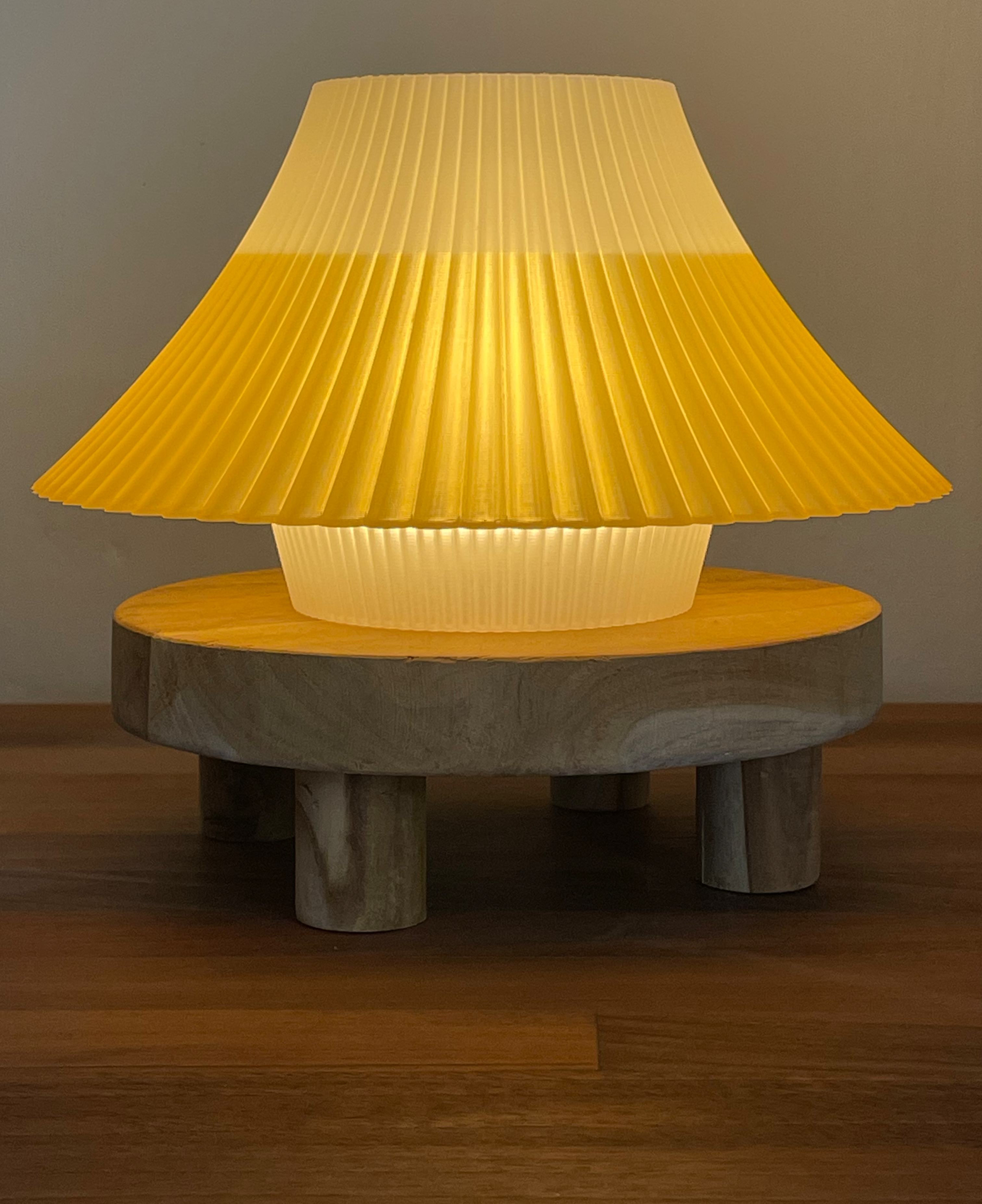 Yellow and white Mount Fuji inspired lamp on a wooden stand